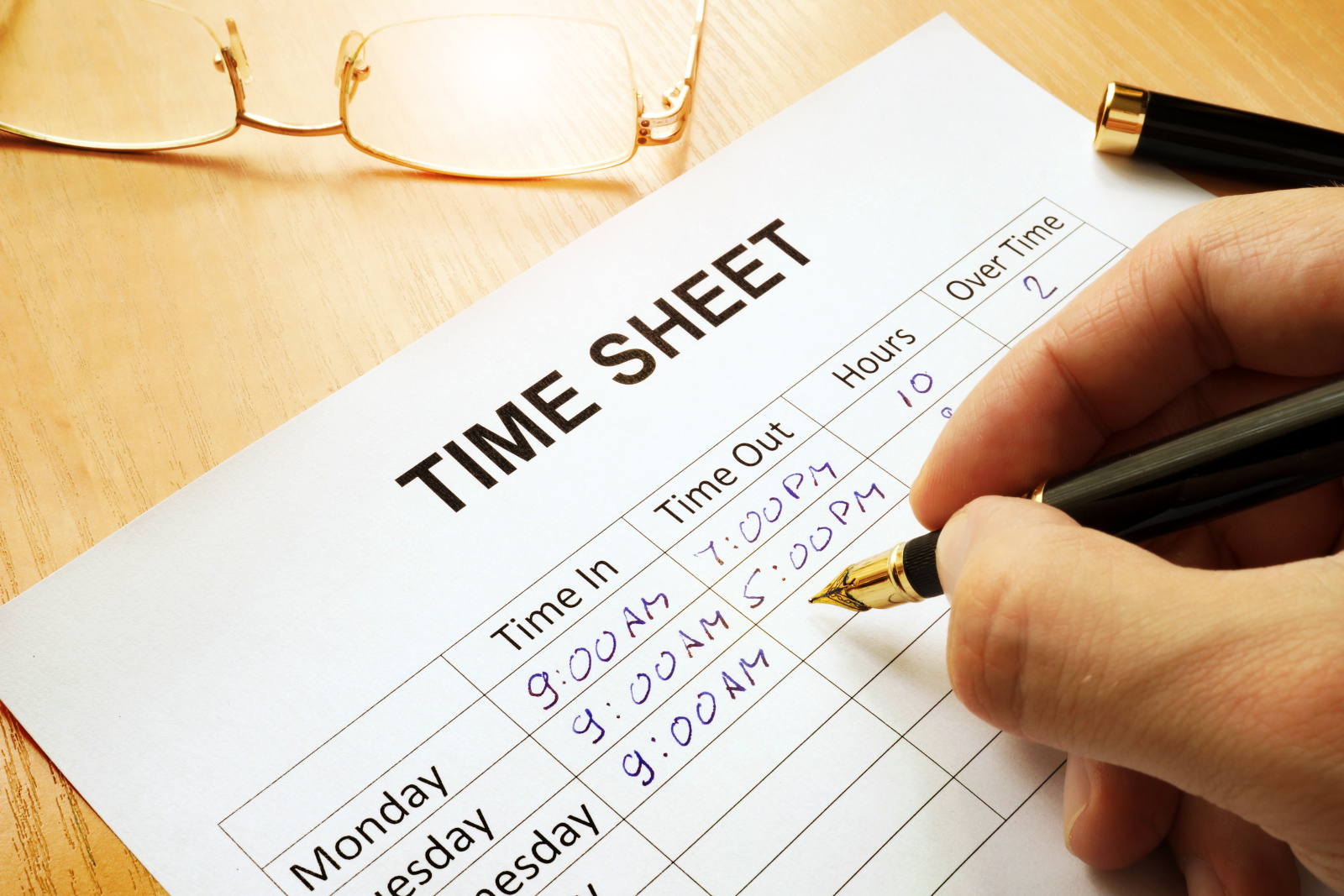 Records work hours in a time sheet. Image showing outdated paper timesheet submission