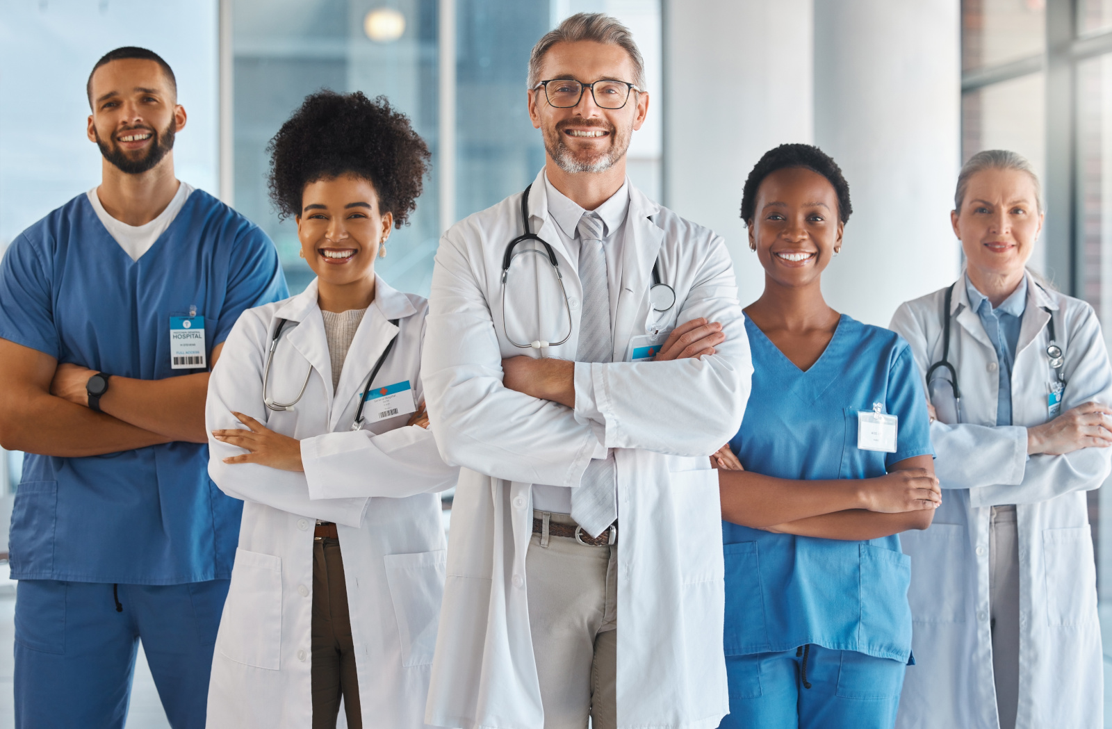 Doctor, team and hospital at work smile together for portrait in medical facility. Medic, nurse and healthcare in clinic with workers showing happiness, confidence and diversity for teamwork in Miami