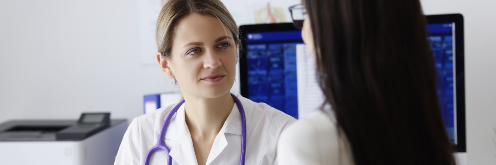 Patient on appointment explain problem to medical worker in clinic