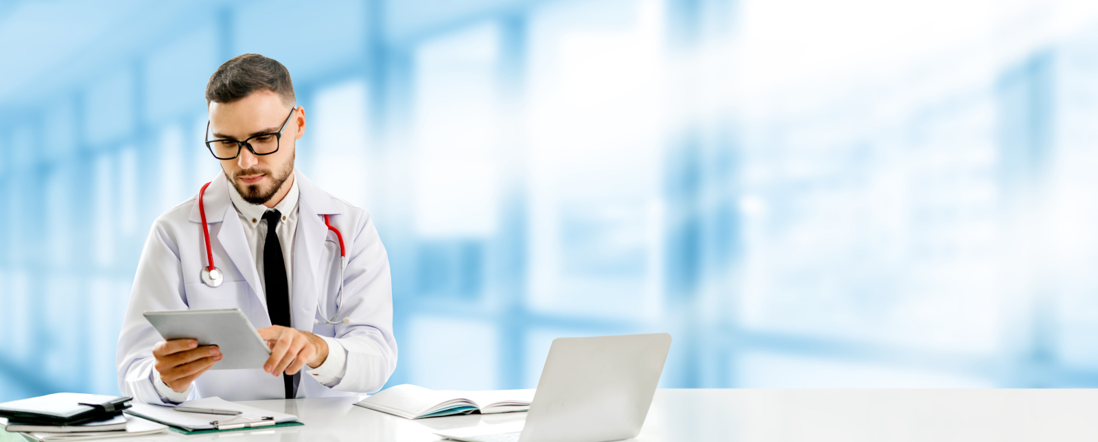 Doctor using tablet computer at the hospital. Medical healthcare and doctor staff service.