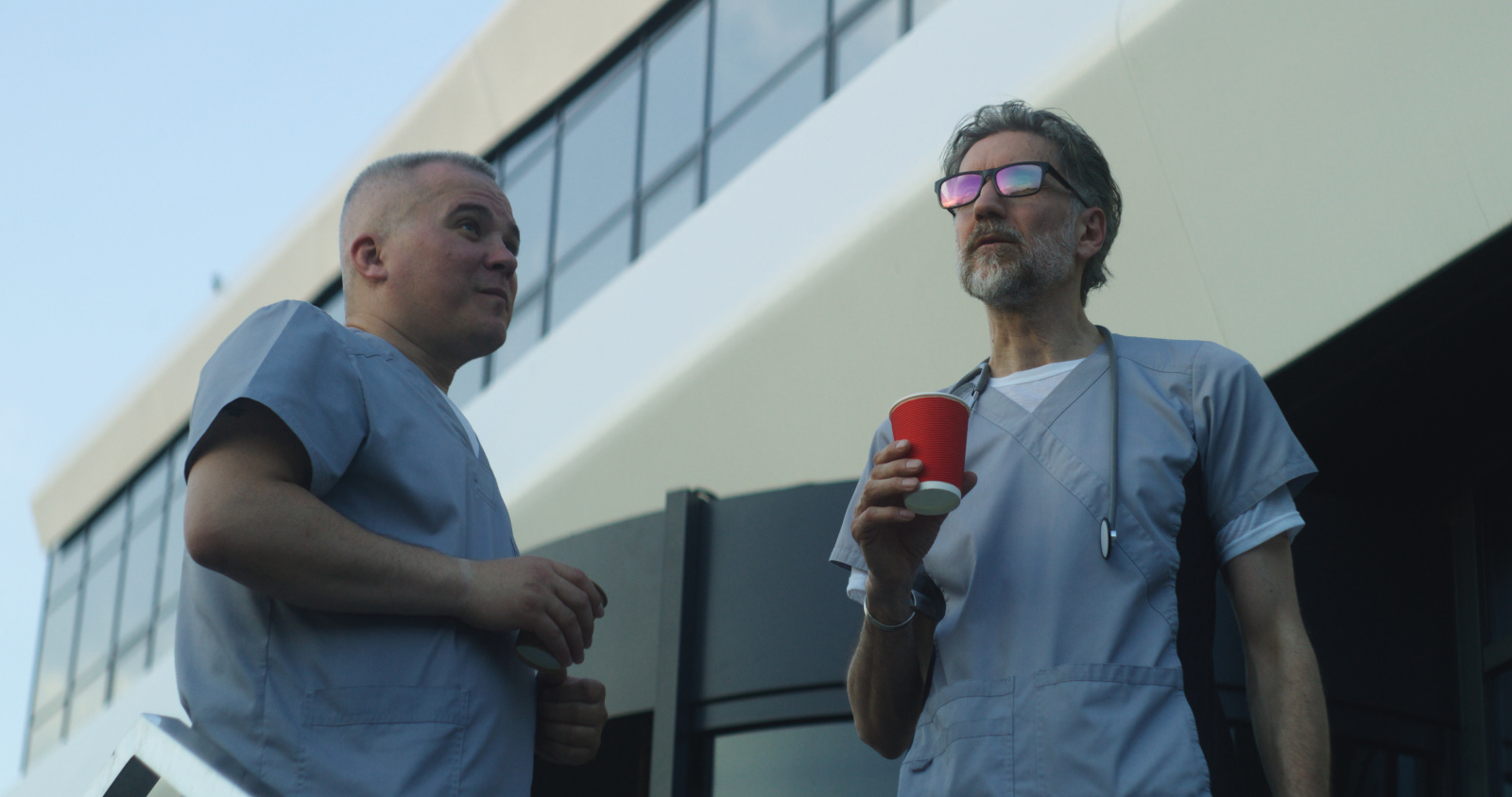Medics drink coffee during break and talk near medical center Managing breaks in healthcare with YouRecruit