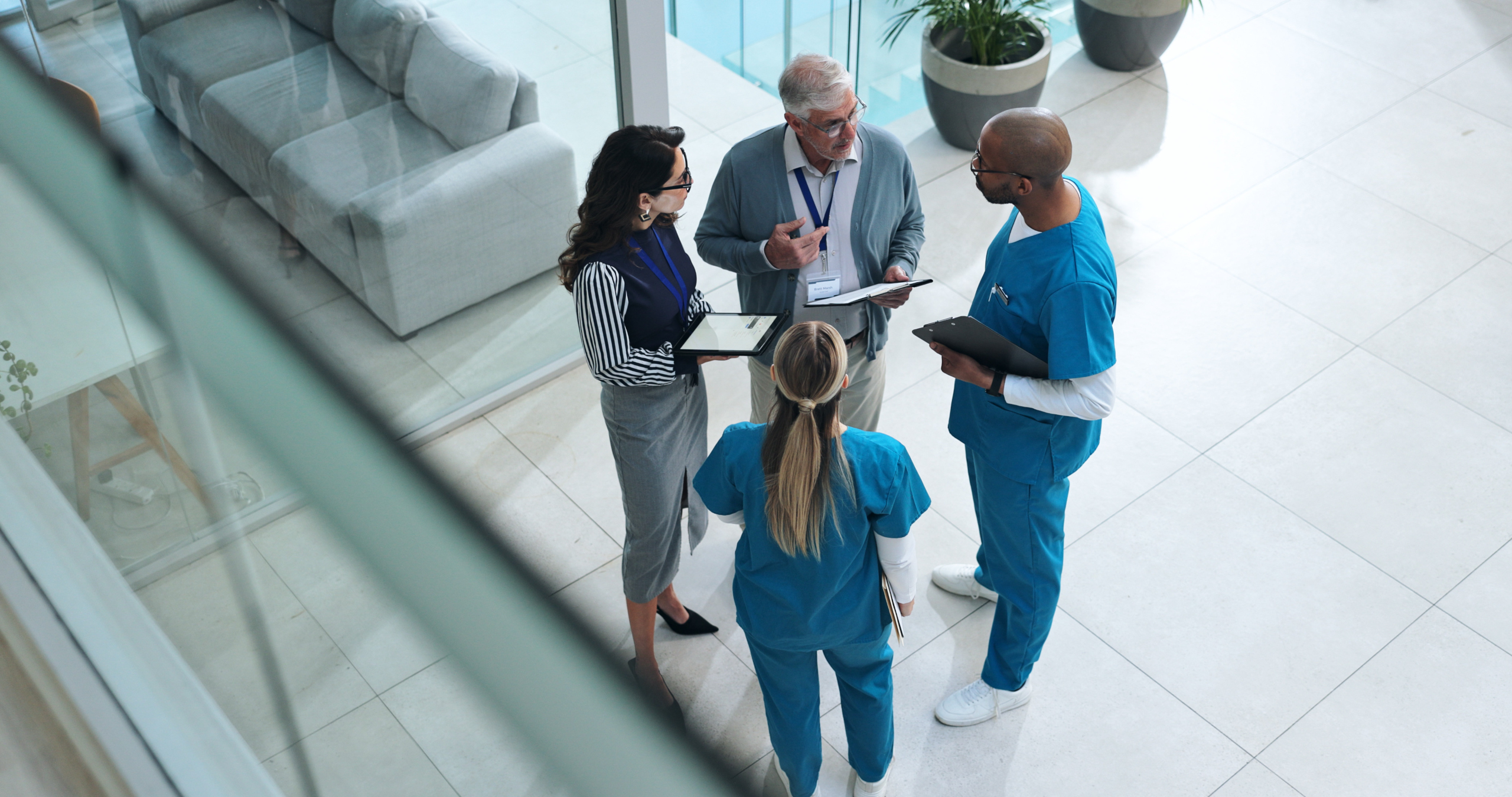 as1014841165-doctors-team-with-tablet2 Hospital shift managers with tablets conversing with two temporary employees: YouRecruit employee availability management