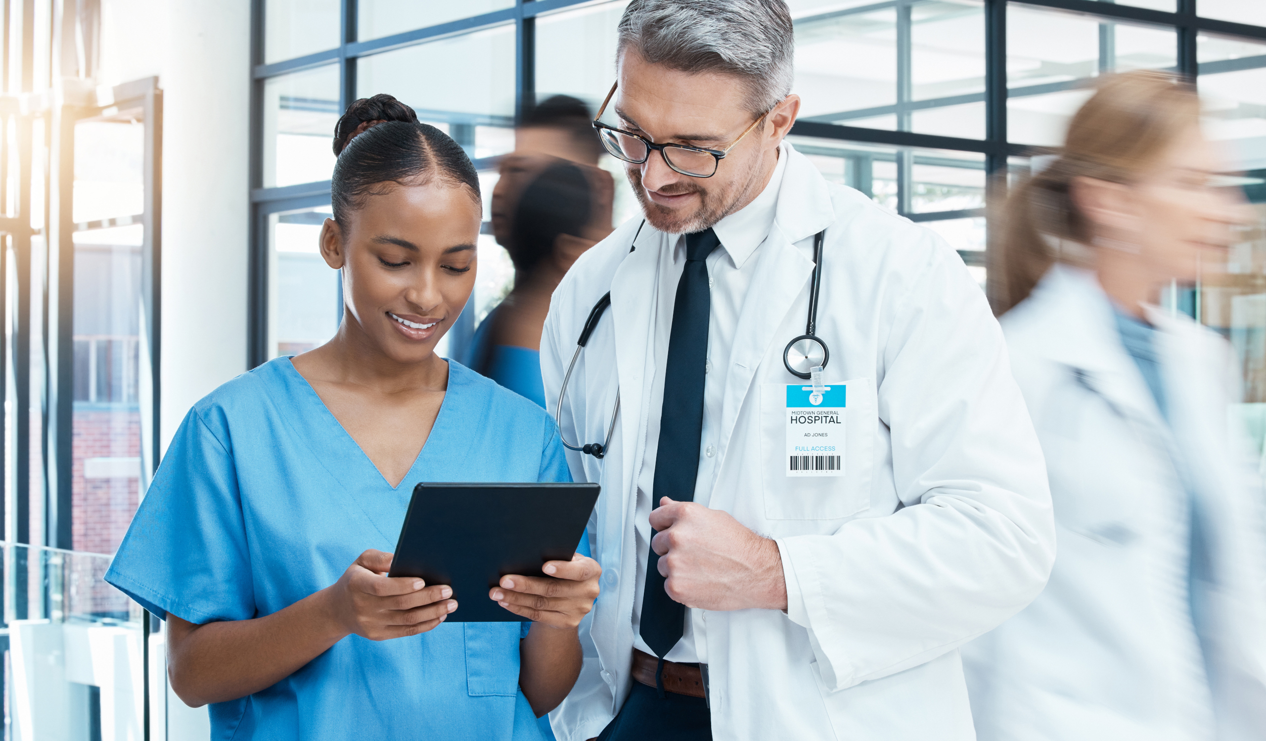 Nurse having her timesheet signed off by shift manager on a tablet: The WorkTracker time recording software and rota app