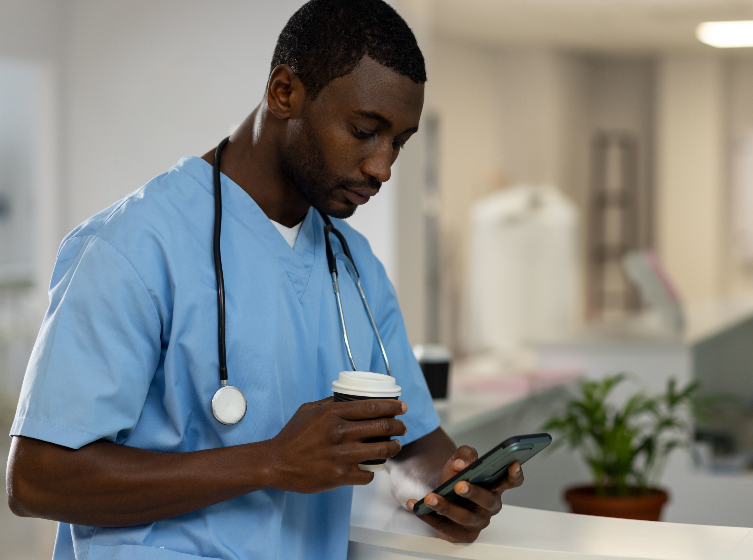 Temporary healthcare employee with smart device entering timesheet data after shift: The WorkTracker mobile timesheet app
