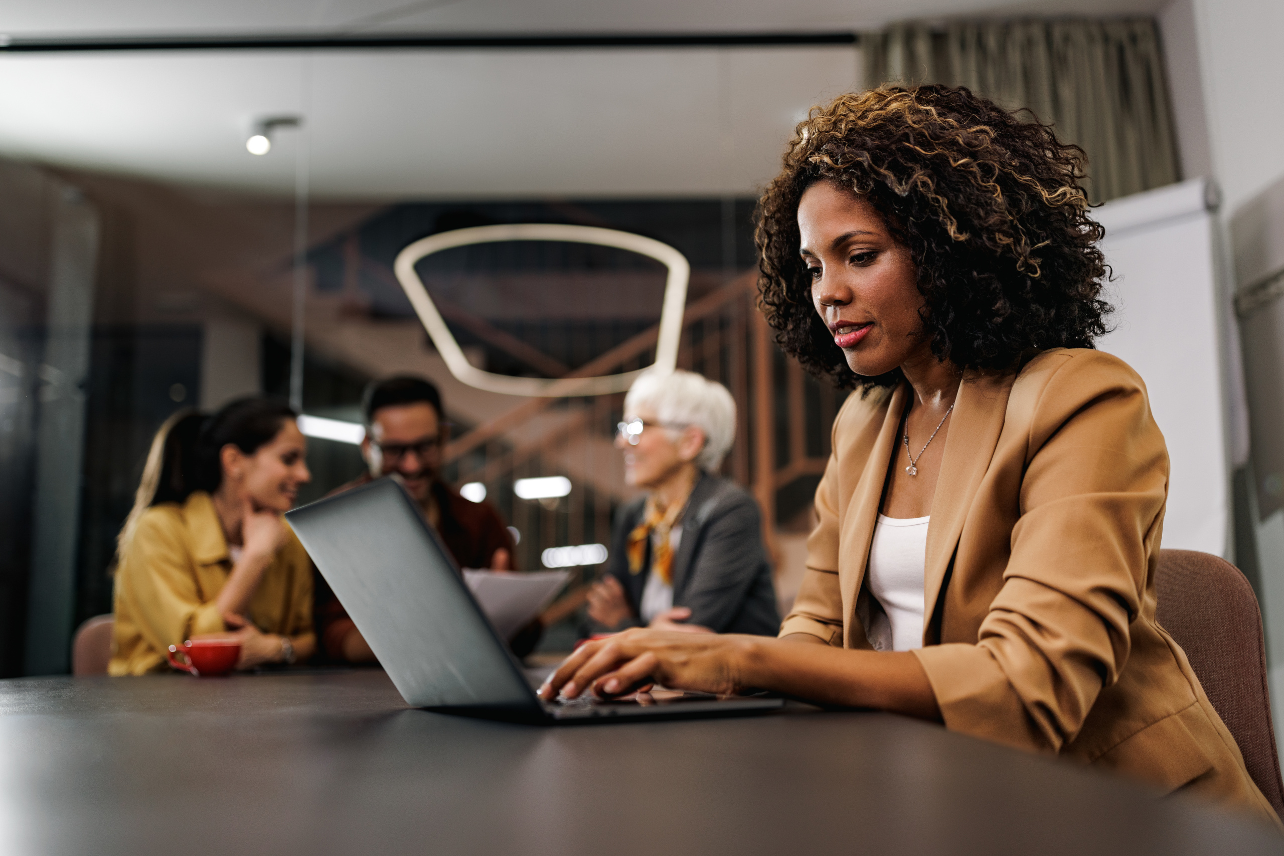 Recruitment agency consultant at desk with laptop: The YouRecruit, Temp Manager and WorkTracker temporary staffing software