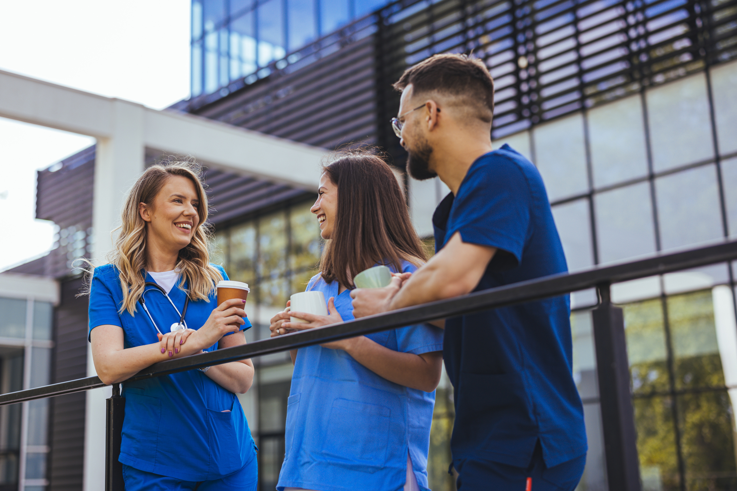 A group of happy healthcare staff in hospital corridor during break in shift: The YouRecruit temporary staffing software