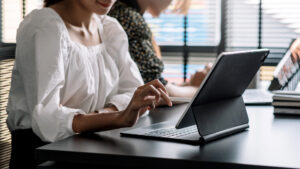 Recruitment agency consultants in office with laptop: Using the Temp Manager recruitment agency timesheet software