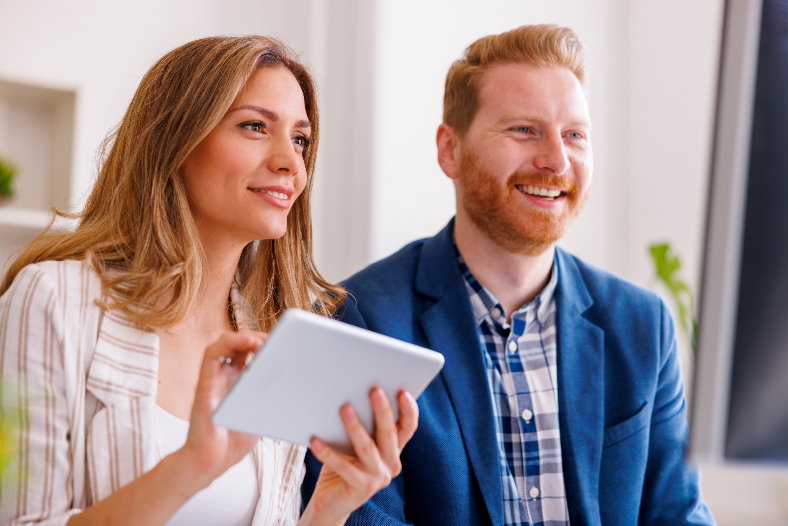 Male and female recruitment agency temporary employees with tablet during the candidate onboarding process: WorkTracker