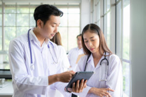 Doctor approving timesheet of temporary junior doctor in hospital setting: The WorkTracker Healthcare Staffing App