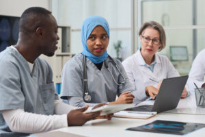 Group of medical professionals receiving mandatory training to stay role compliant: Compliance administration with YouRecruit