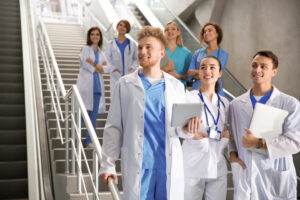 New healthcare employees on the stairwell of a hospital: Candidate onboarding with the YouRecruit staffing agency software