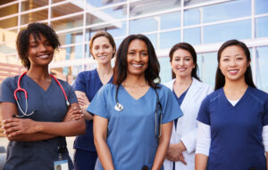 A group of happy female nurses outside a hospital: The YouRecruit workforce management system and staffing agency software